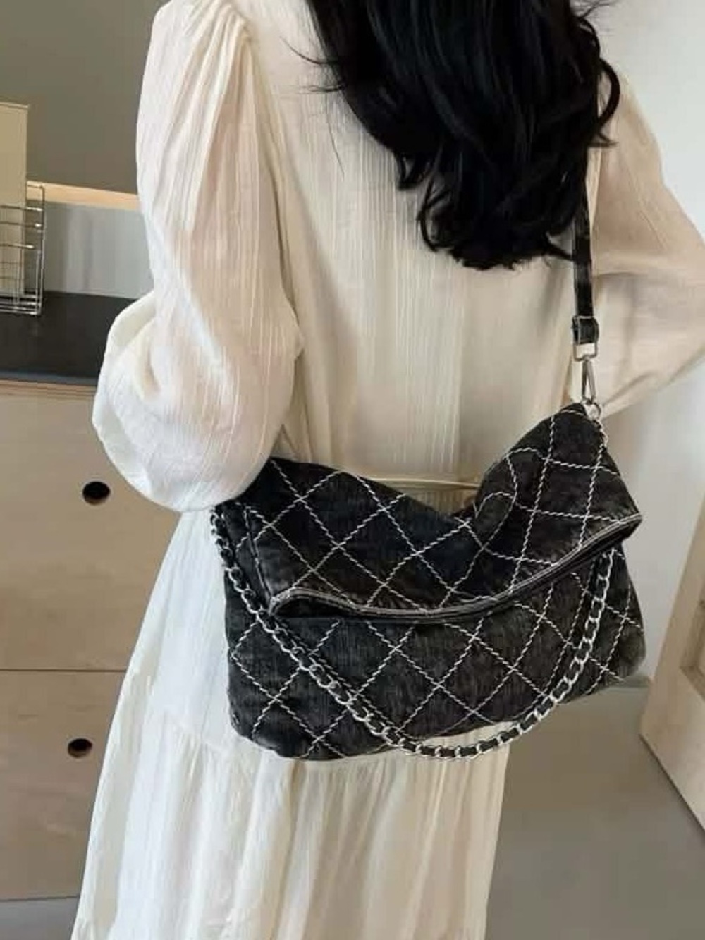Quilted black denim purse.  Versatile. Detachable shoulder strap.  Snap closure.
